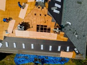 Roof decking installation with plywood sheathing and blue underlayment membrane from above