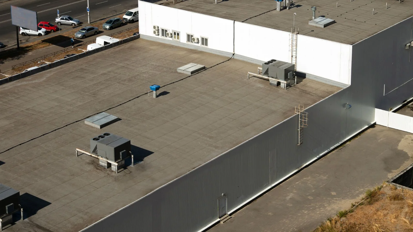 Commercial flat roof with membrane system, HVAC units, and sealed penetrations